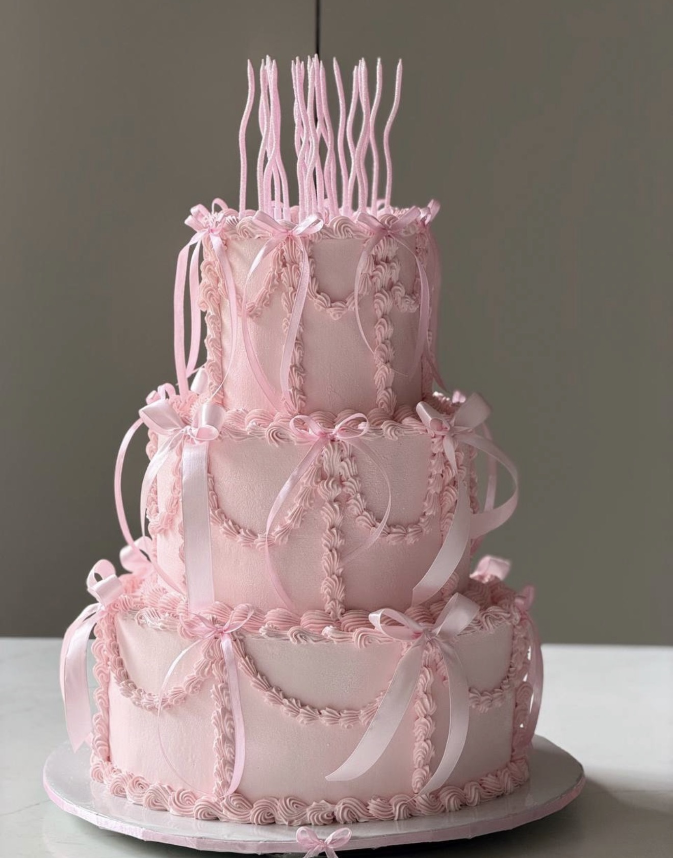 MKD Bakery pink tiered wedding cake with ribbons