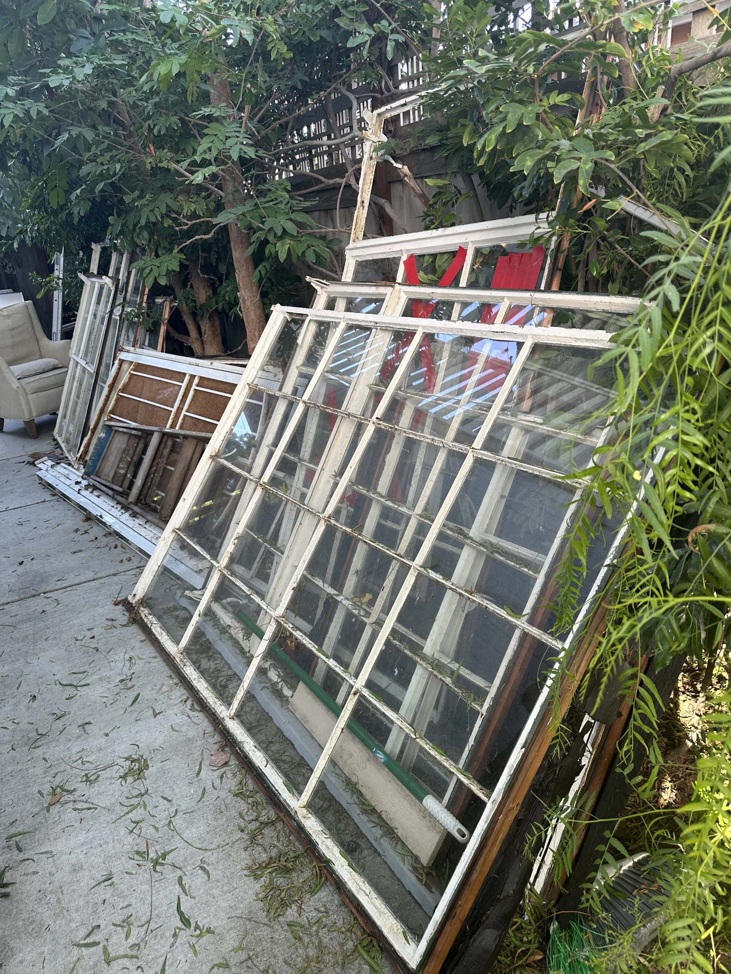 Before junk removal — furniture, mattress, and household items left in apartment complex courtyard
