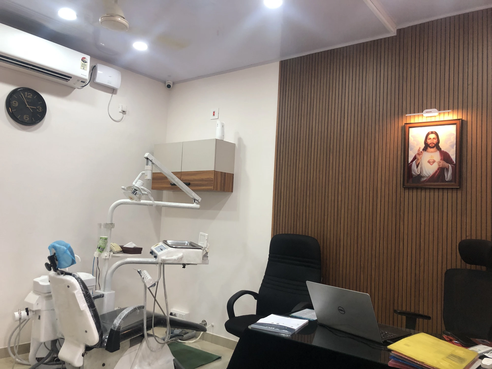 Treatment room with dental chair and consulting desk