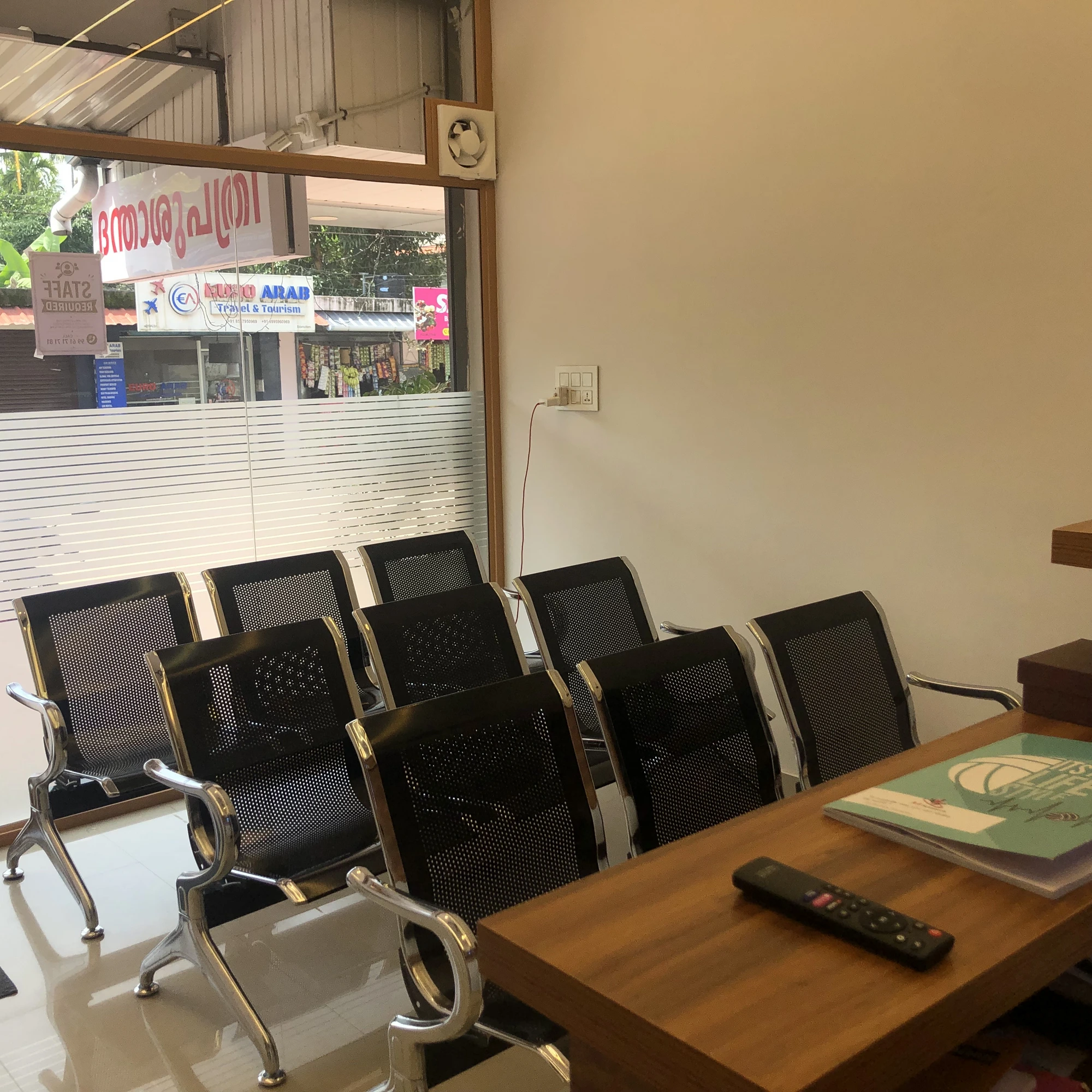 Waiting seats and window looking onto Edamuttam street