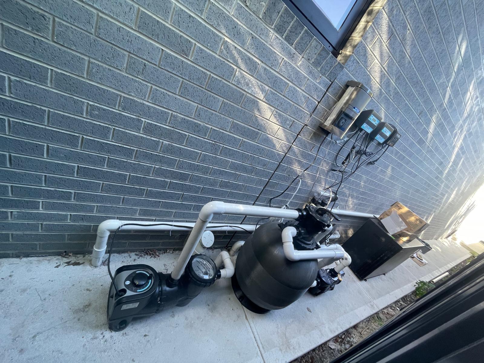 A pool sand filter and pump during a professional filter cleaning service at a Melbourne home